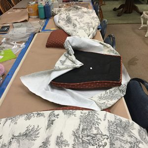 applying the Toile fabric to the chair seats